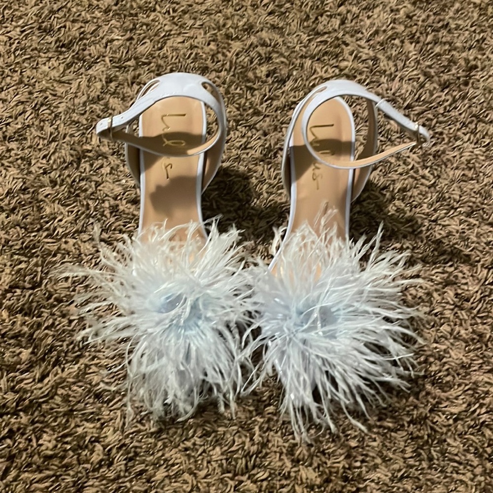 Lulu’s feathered high heel. Warn once